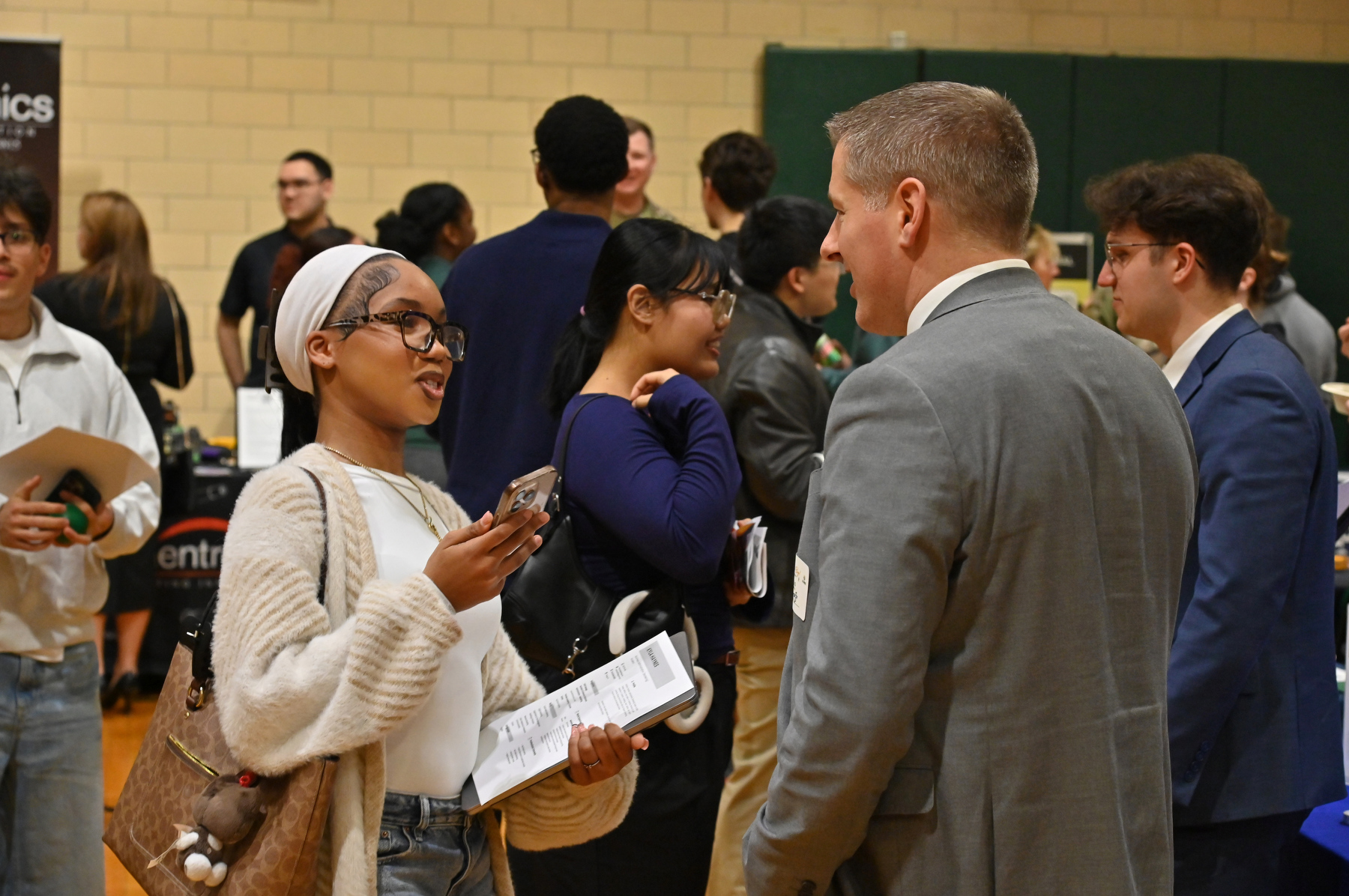 Over 100 companies, employers, agencies and organizations came to the Dream Big Spring Career Fair in March to meet with over 600 students about internships, summer positions, volunteer opportunities and full-time jobs after graduation. Pictured, Kyla Haynes, a sophomore business administration and marketing major, talks with Kurt D'Angelo, a two-time Oswego alumnus and vice president of Equitable Advisors.