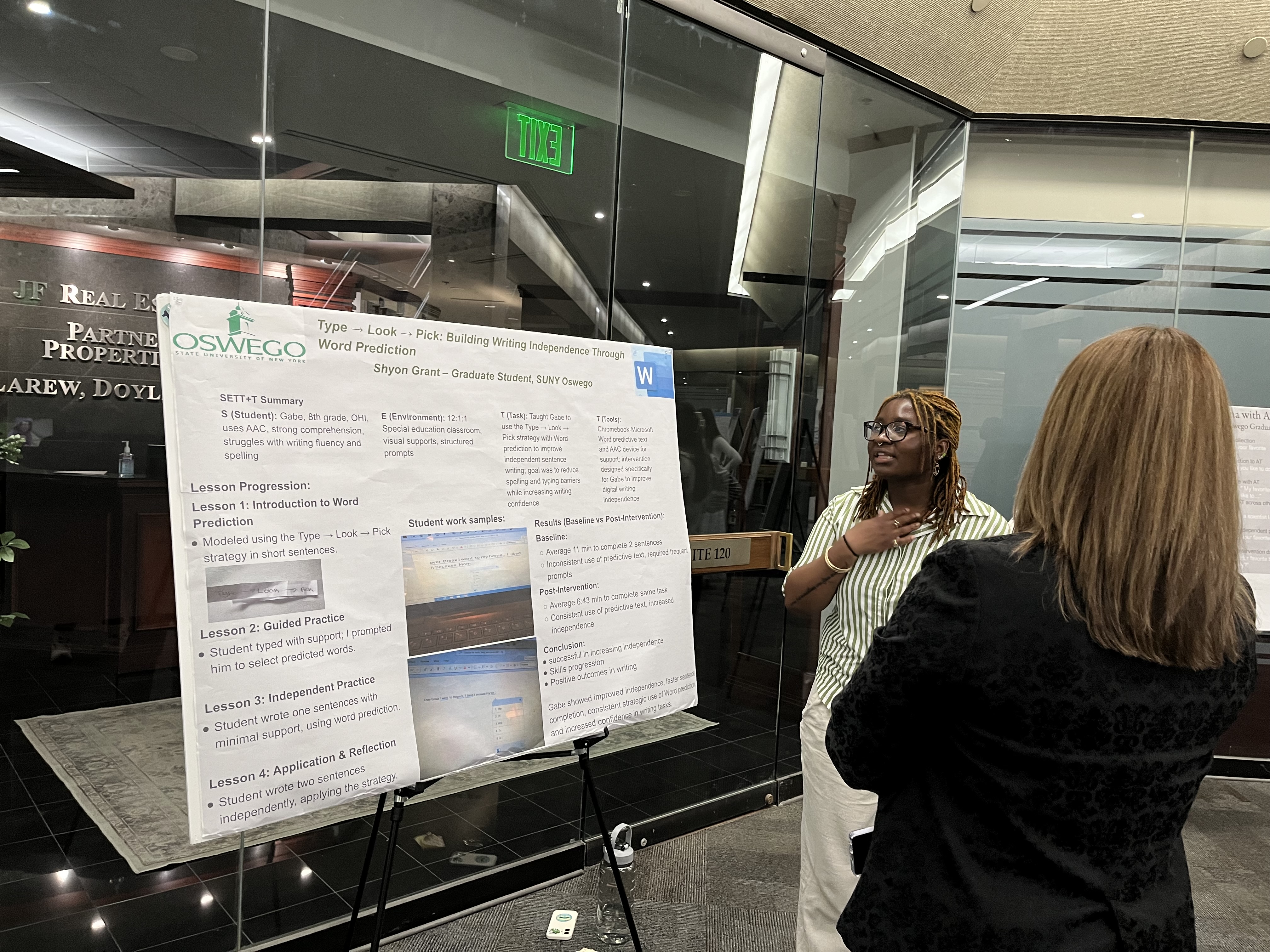 The more than 30 graduate student poster presentations at the Quest preview event April 21 at SUNY Oswego at Syracuse included Shyon Grant, shown discussing “Type Look Pick: Building Writing Independence Through Word Prediction” with Jill Pippin, dean of the Division of Extended Learning.