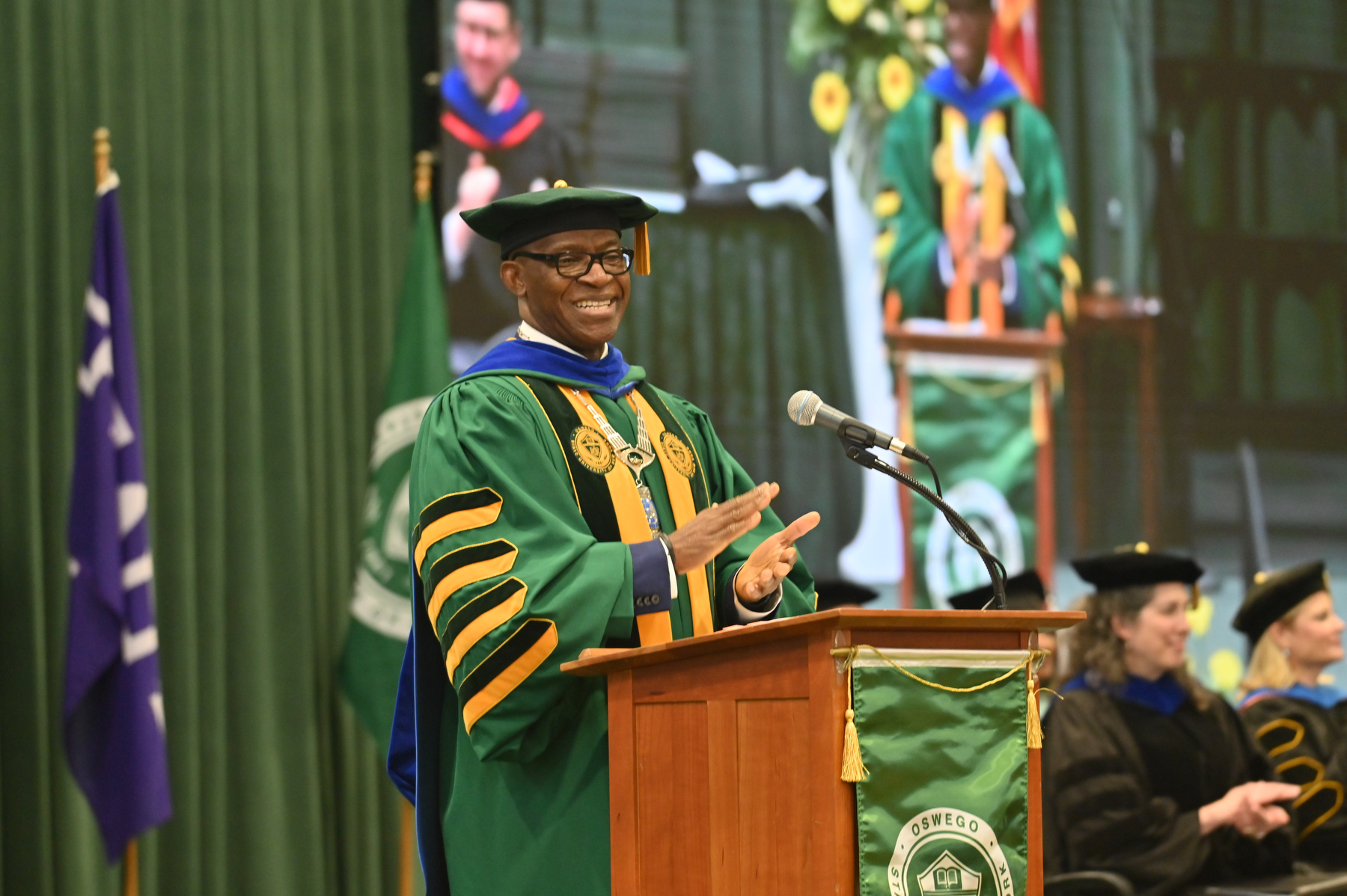 President Peter O Nwosu applauds the graduates during his welcome remarks at the 12:30 p.m. ceremony for the College of Business and Entrepreneurship.