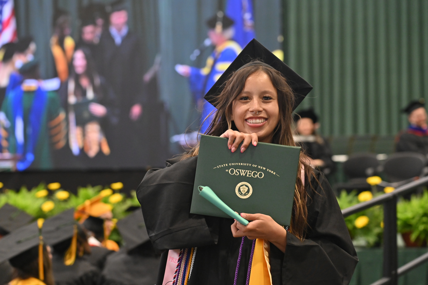 Kaedyn McClain, who earned a degree in human resource management and hails from Fort Worth, Texas, enjoys the moment during the ceremony for the College of Business and Entrepreneurship.