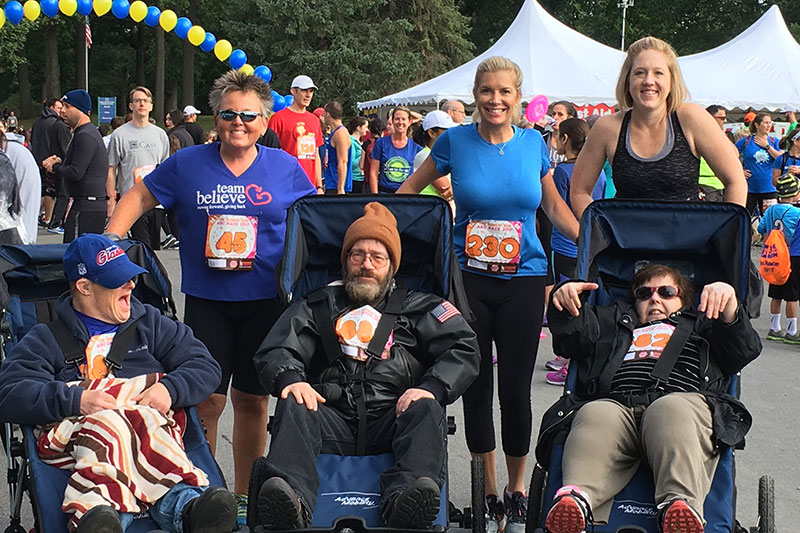 Faculty members serve as tandem runners for disabled athletes in the ARC of Onondaga 5K fundraiser