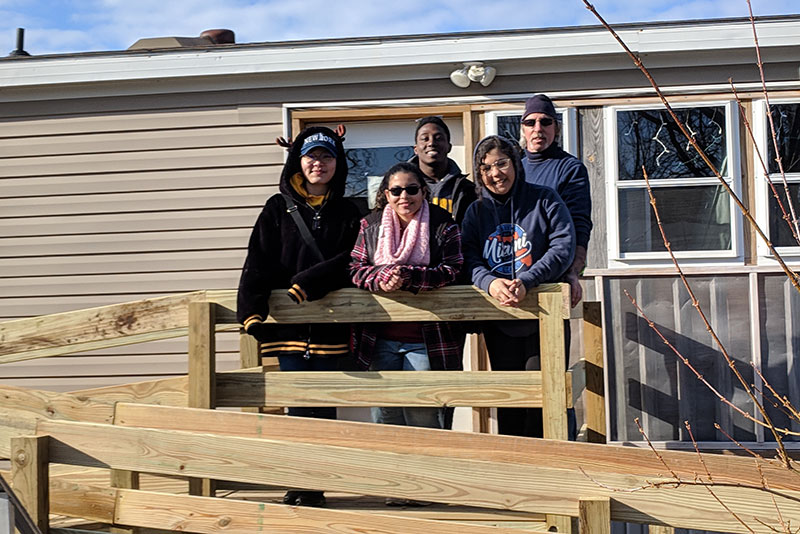 Students help build a ramp for a local resident