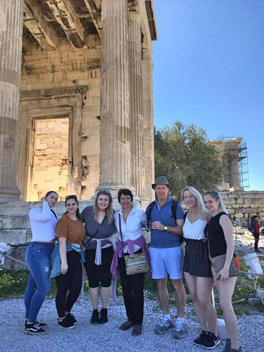 The Athenian Acropolis serves as backdrop for this photo of a group in the study-and-travel course