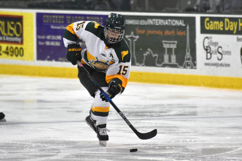 Olivia Ellis of the women's hockey team skates with the puck