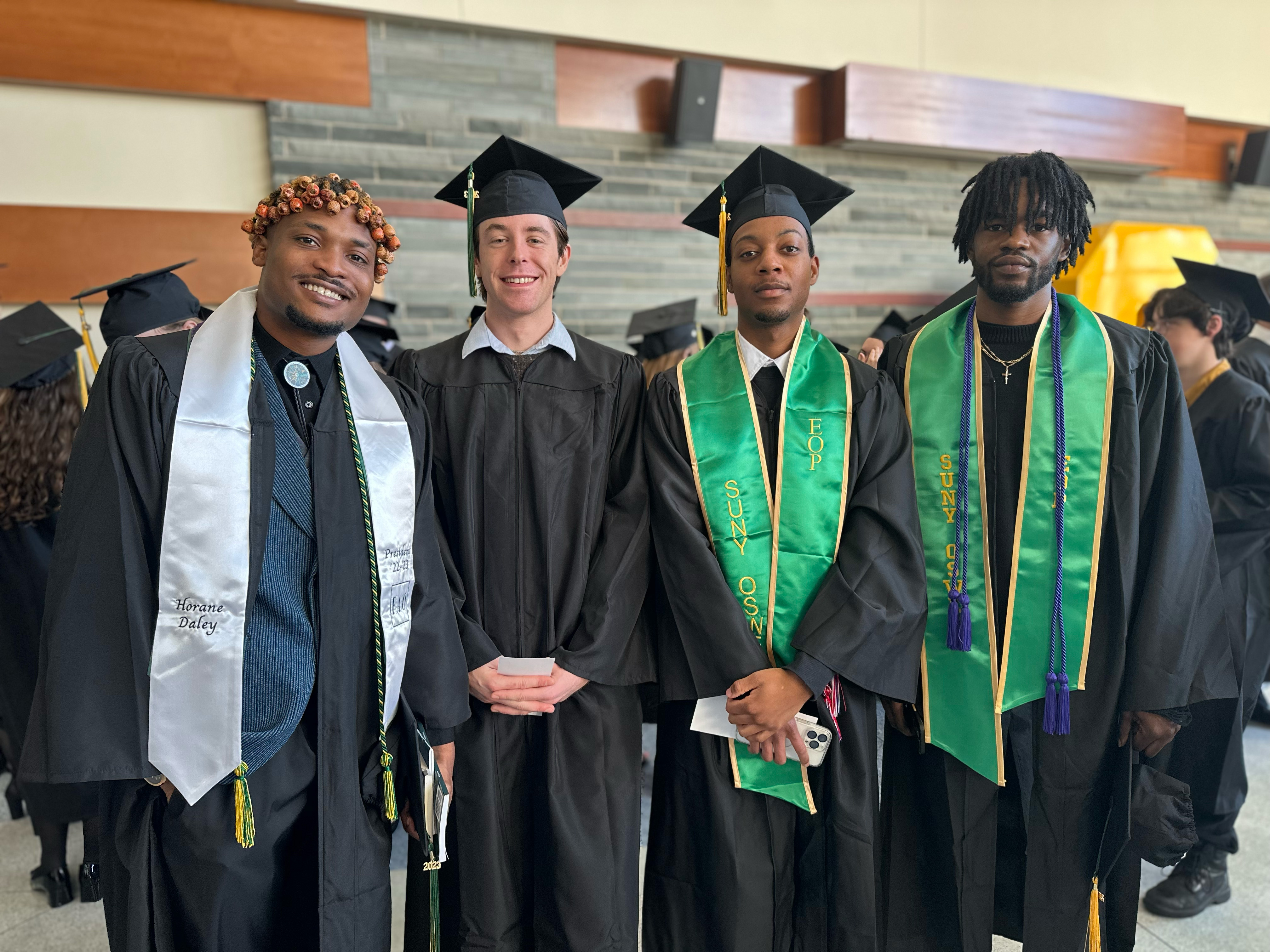 Students taking part in December Commencement gather for photos and conversation before lining up by school in the Marano Campus Center food and activity court.
