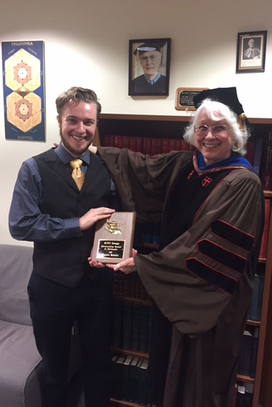 Philosophy honoree Phoenix Boisnier and department chair Jean Chambers display Boisnier's award