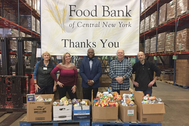 Isiah Brown with Food Bank of CNY representatives with campus donations