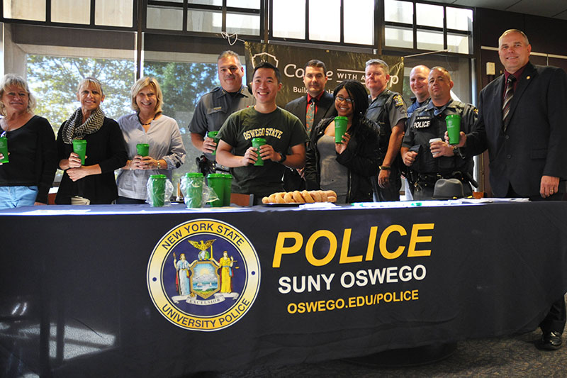 University Police officers, students and staff pause for a photo during Coffee with a Cop