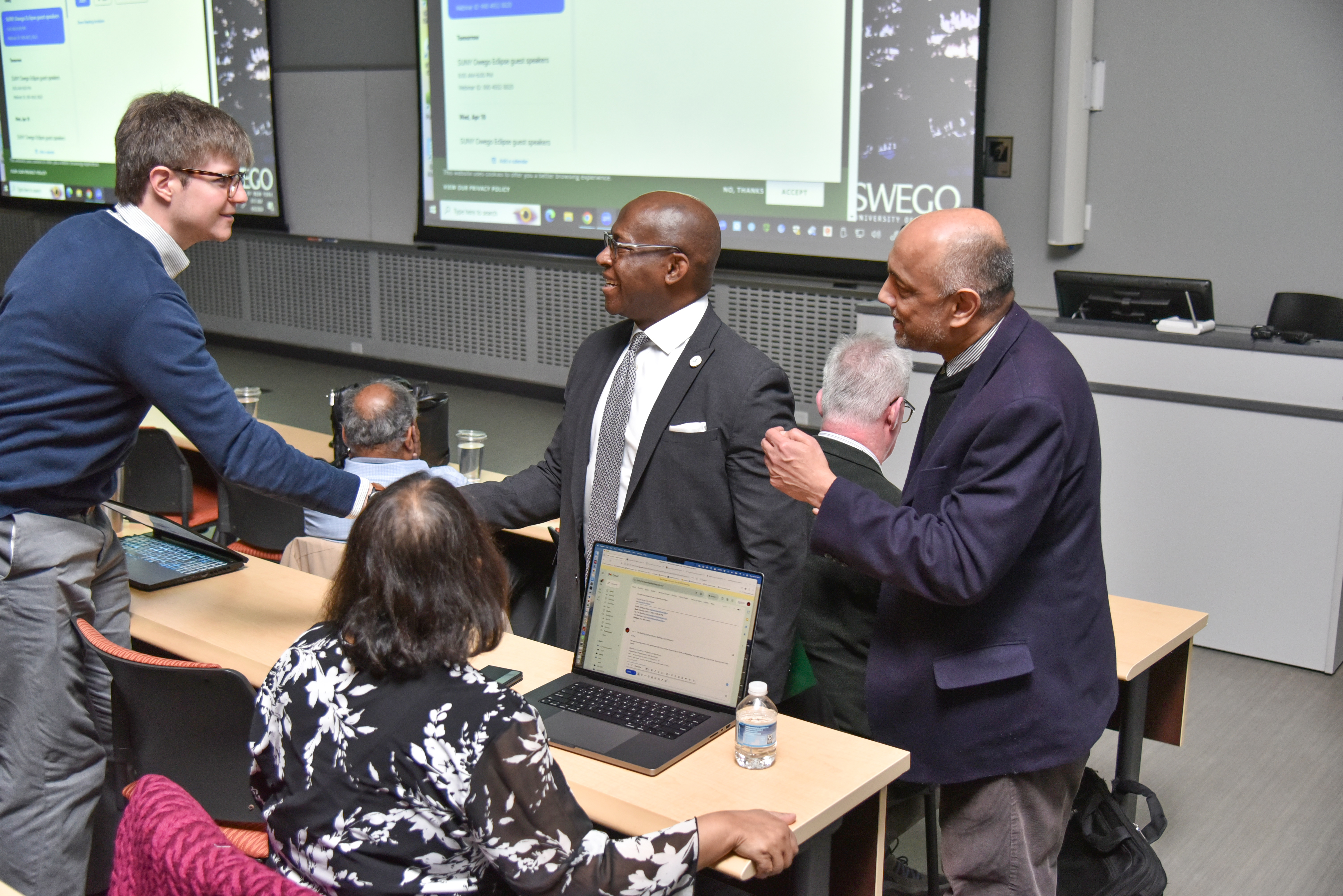 SUNY Oswego President Peter O. Nwosu and Distinguished Professor of Physics and Astronomy Shashi Kanbur greet Earl Bellinger, a 2012 SUNY Oswego graduate now teaching at Yale University. A former research mentee of Kanbur, Bellinger was one of a number of expert guest lecturers Kanbur invited to campus that day for the total solar eclipse.