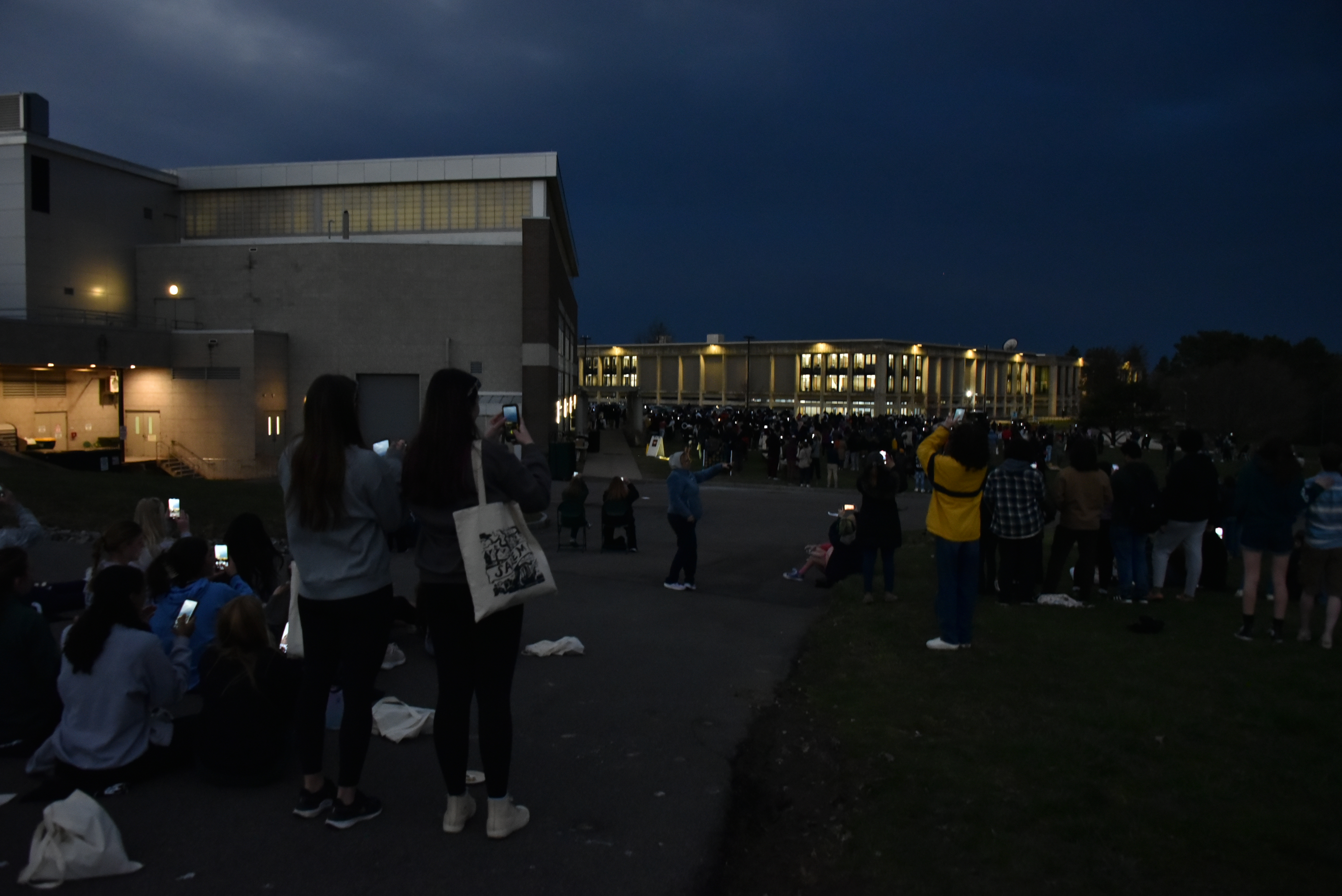 At just before 3:22 p.m. on Monday, April 8, totality occurred over the SUNY Oswego campus as the moon completely blocked the sun for a total solar eclipse, casting the campus into shadow for nearly three and a half minutes. At a watch party behind Swetman Gym, the hundreds gathered cheered every time the sun poked out of the overcast day even briefly to provide a glimpse at the once-in-a-lifetime phenomenon.