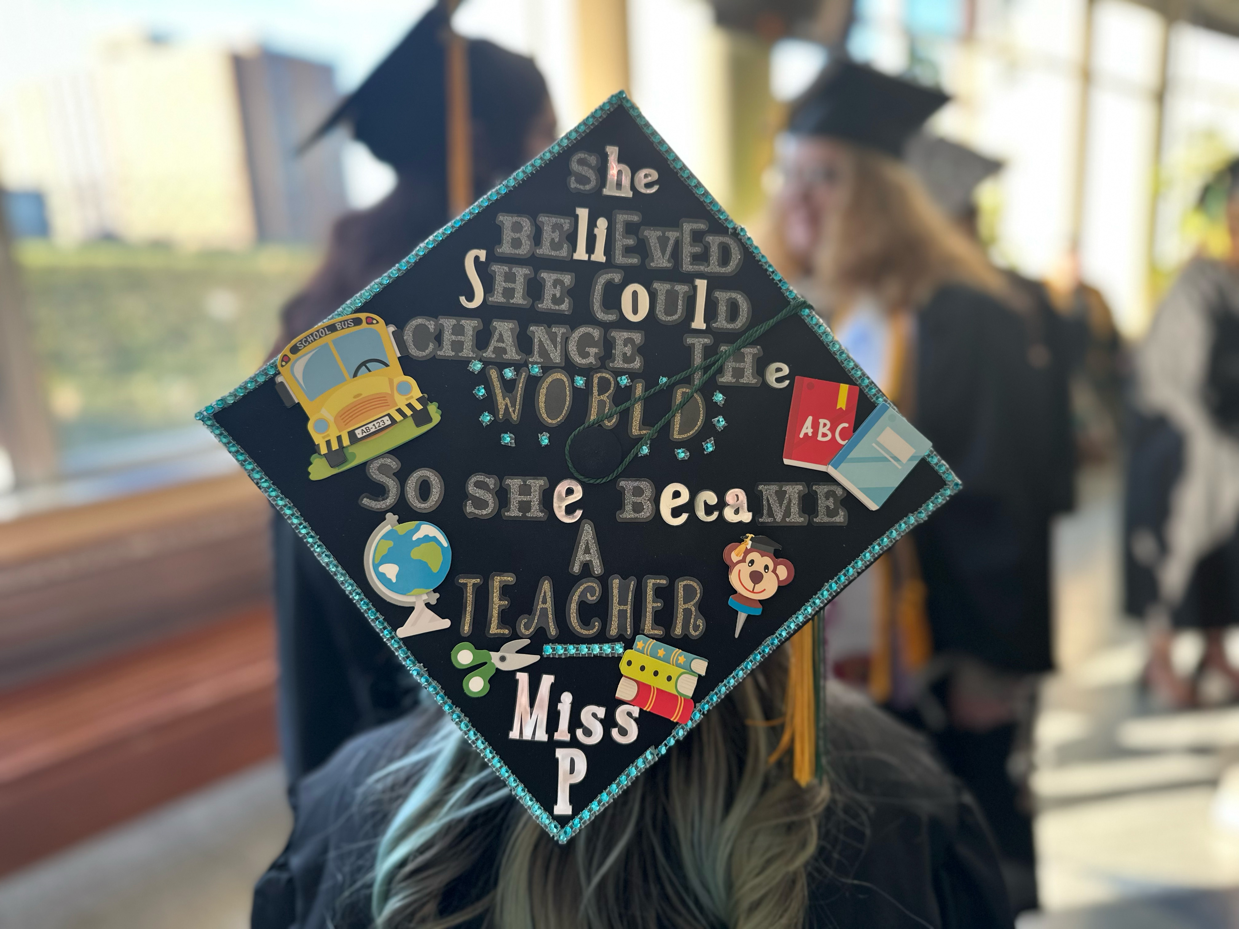 A student from the School of Education shows off their decorated grad cap before the December Commencement ceremony on Dec. 16.