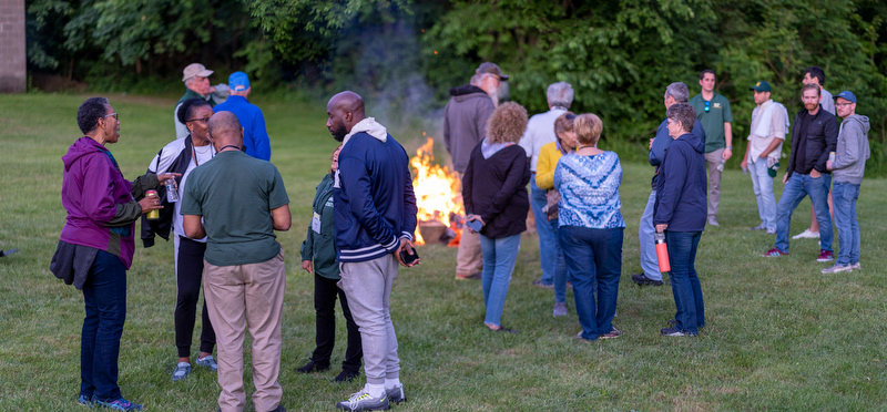 Alumni gather around the bonfire at the Welcome Back Barbecue at Fallbrook. 
