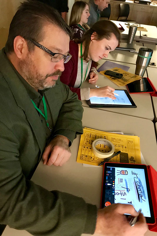 Participants draw with tablets