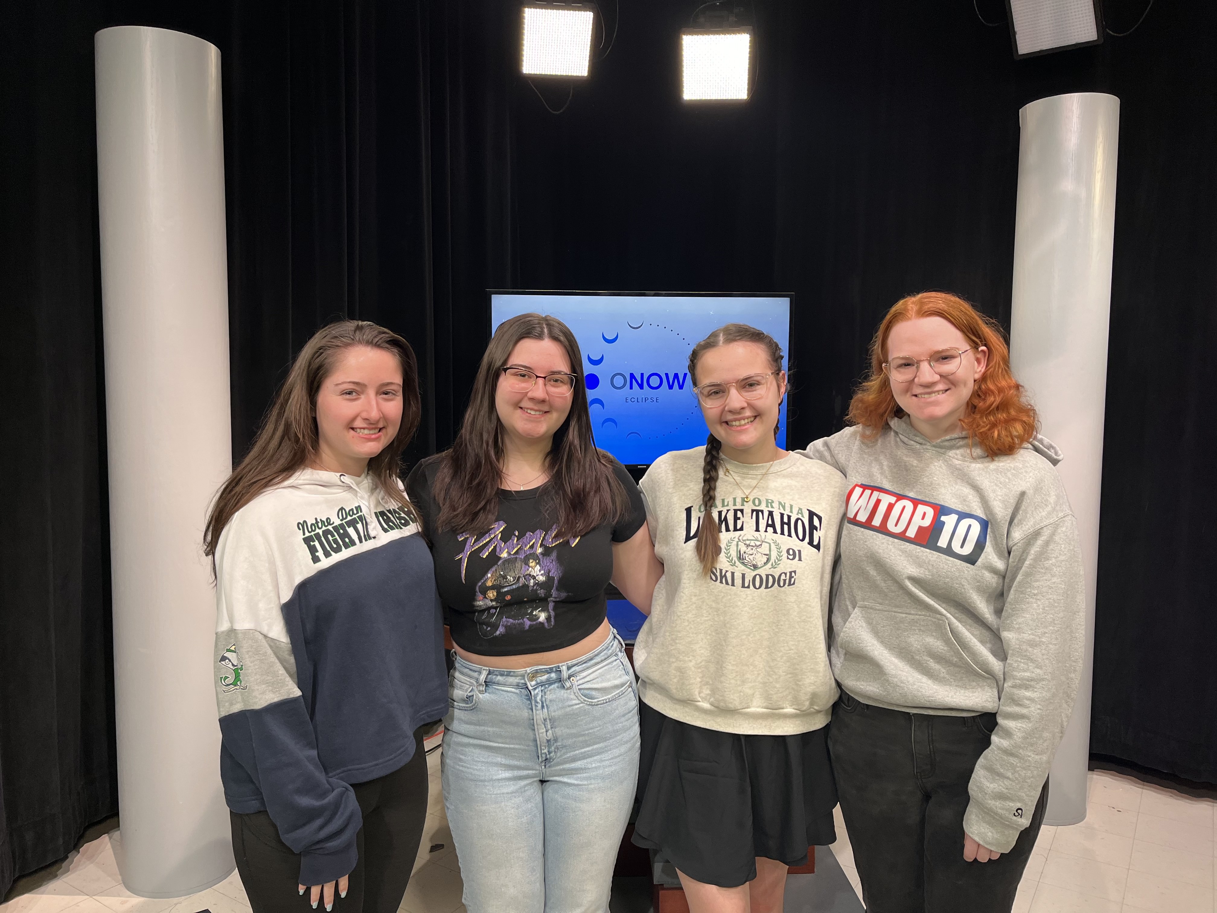 Students on the public relations team in CMA 490: Covering the Eclipse pose on the set of their eclipse broadcast. From left; Bailey Thomas, Sam Citerall, Faith Summerville and Sam Keaney.