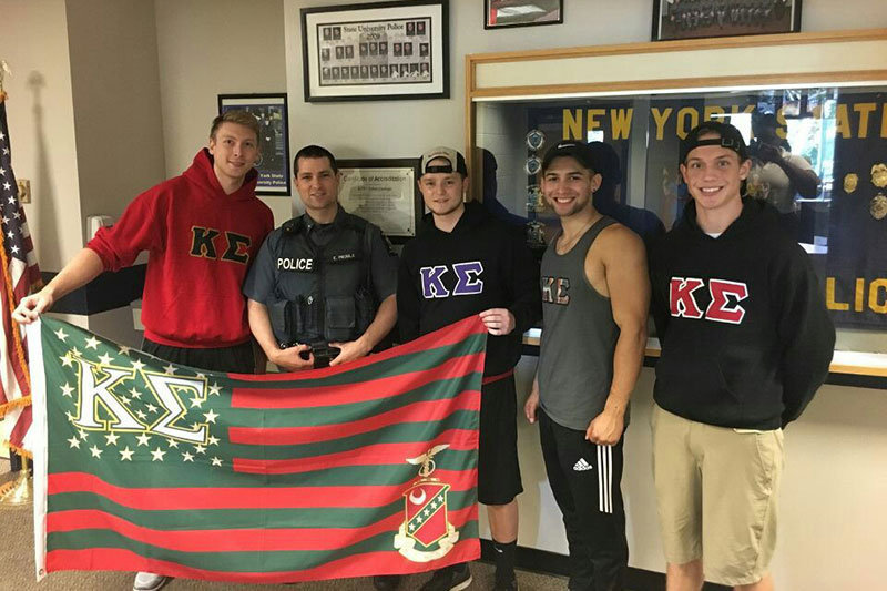 Kappa Sigma fraternity members stop by University Police offices to visit and drop off a thank-you goodie bag