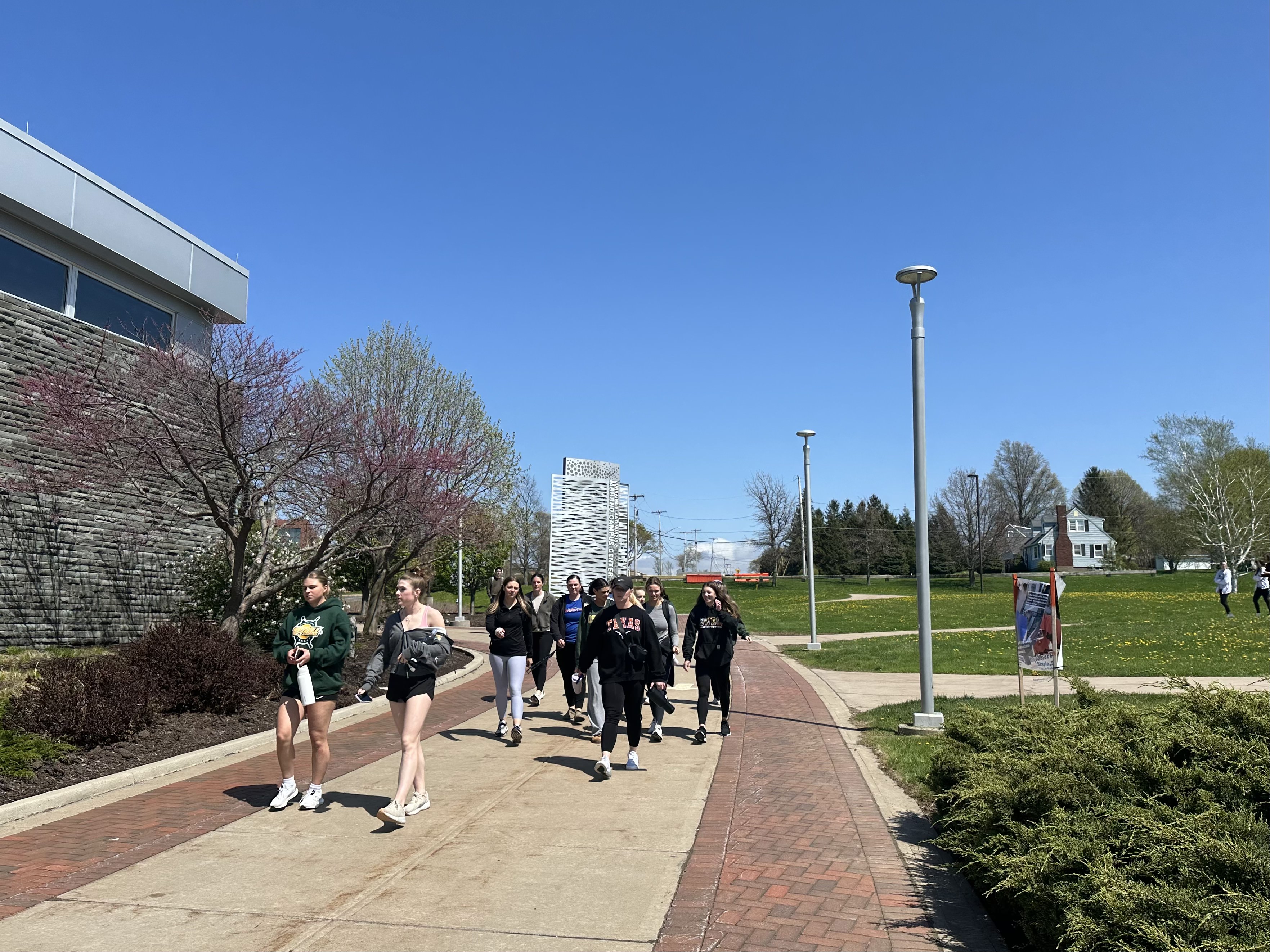 A large group of students participate in Laps with Lakers by walking the path around Academic Quad.