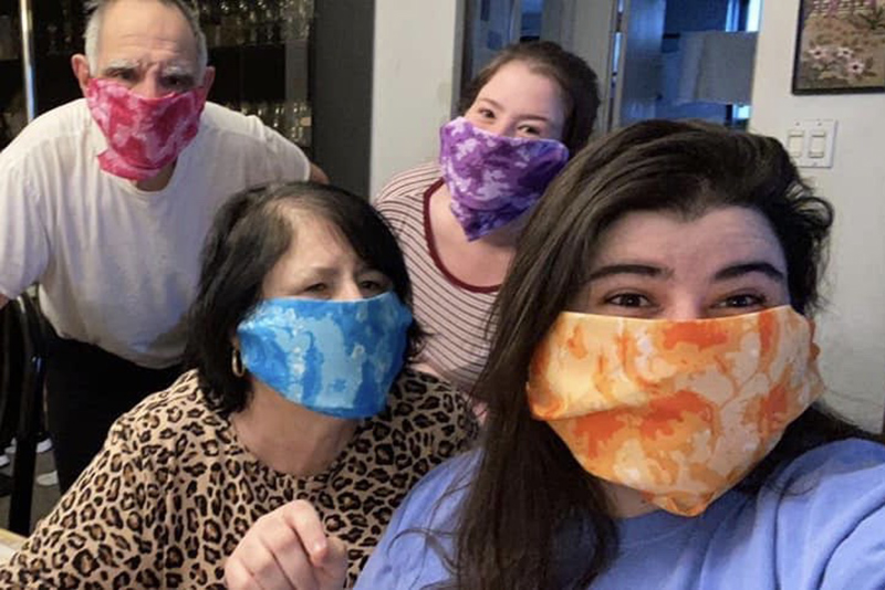 The Lesser family wears face coverings while attending a virtual drop-in with President Stanley