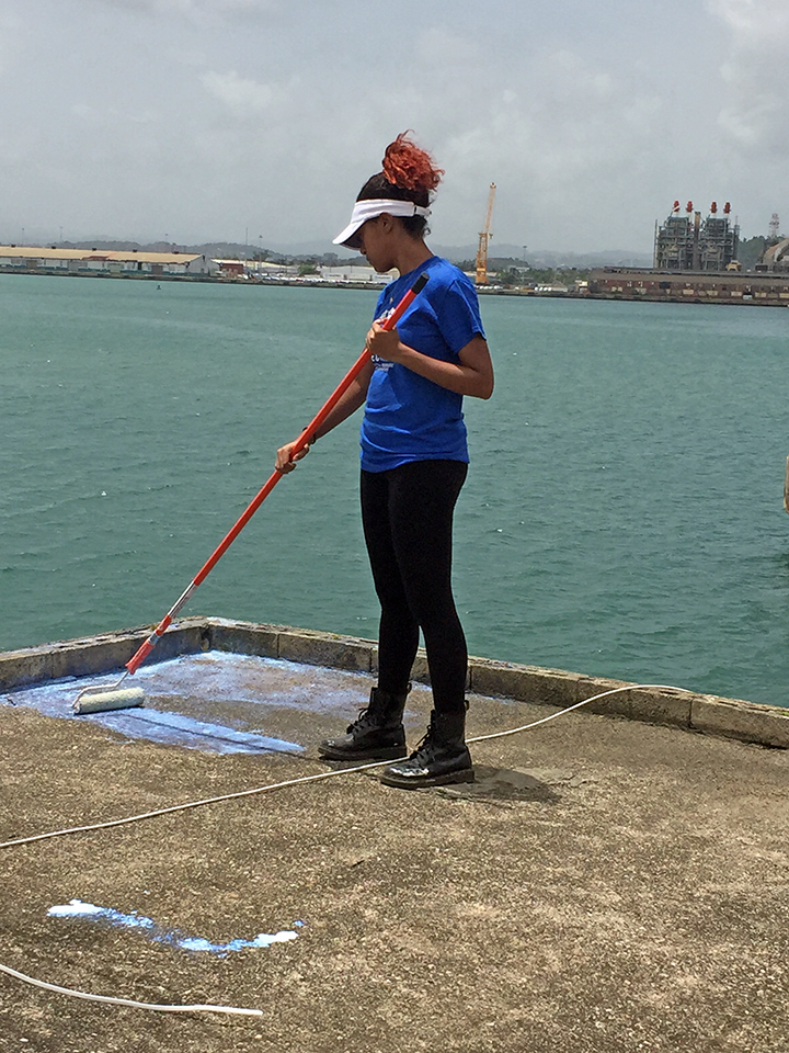 Tatyanna Hiciano primes a roof in Puerto Rico