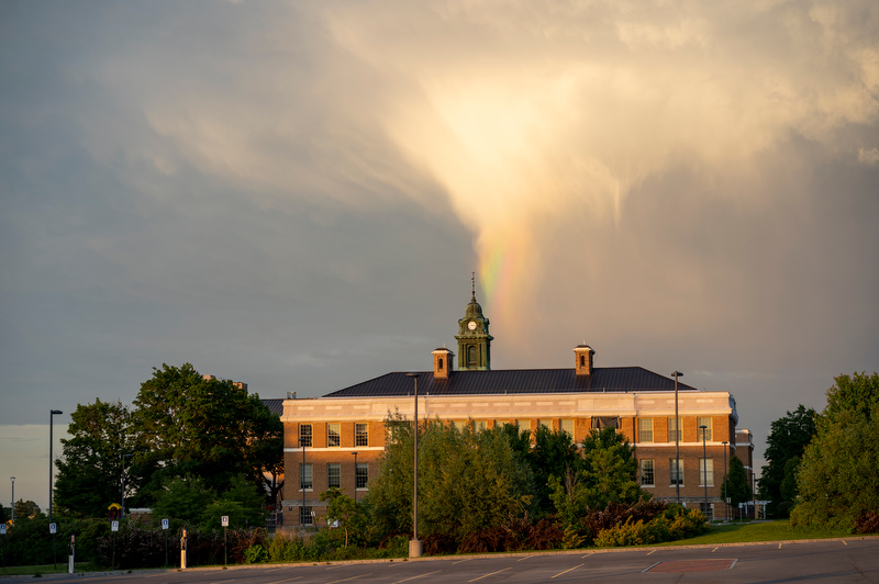 A glorious rainbow appears at sunset over Sheldon Hall during Reunion Weekend.