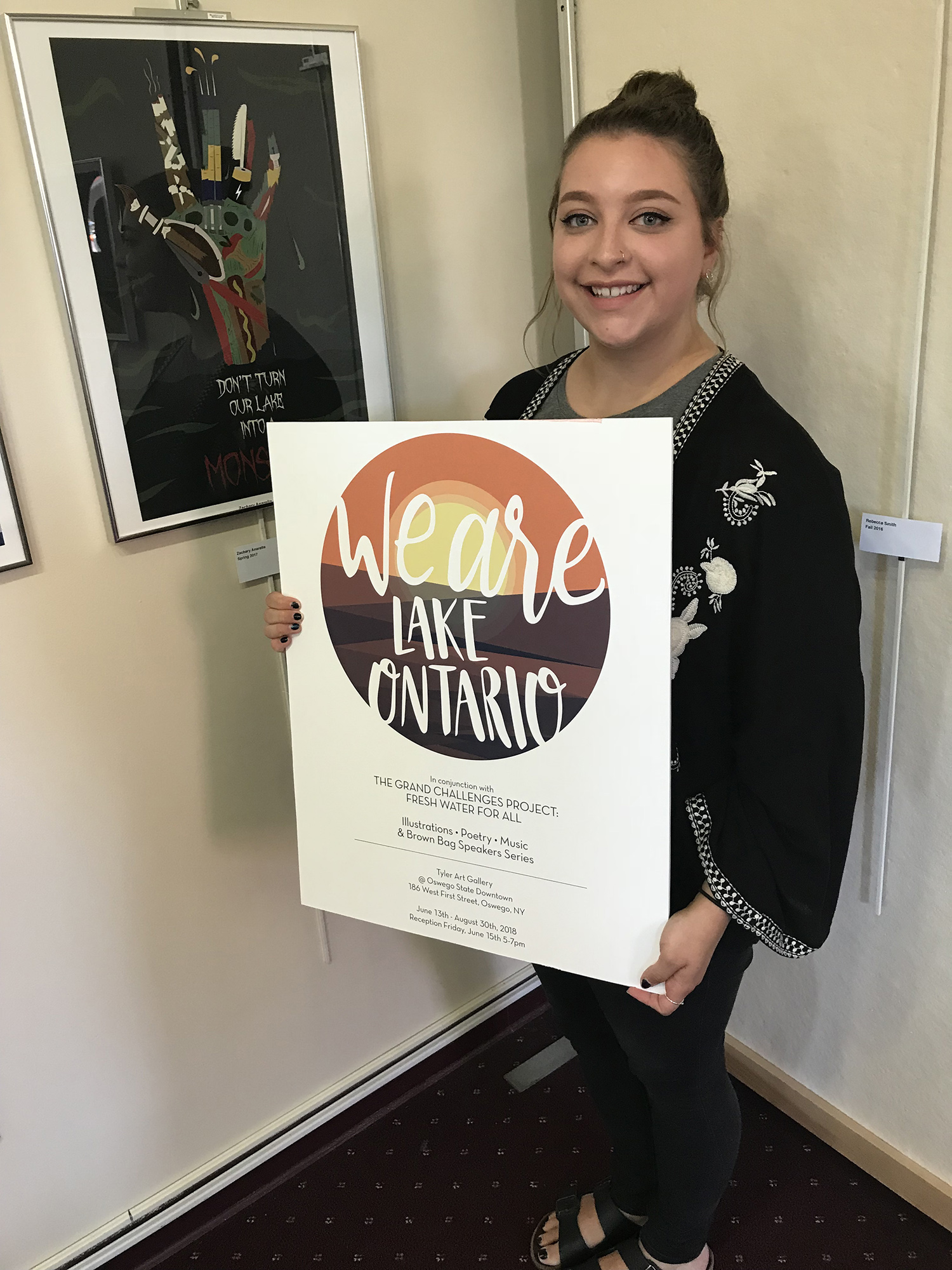 Rebecca Smith holds a logo she helped design