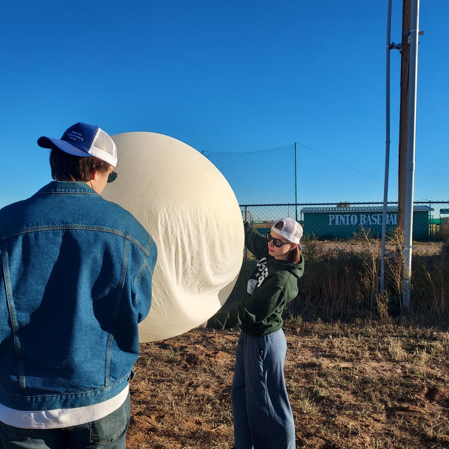 A team of six students and two faculty members headed to New Mexico to conduct research during the Oct. 14 annular eclipse as part of the Nationwide Eclipse Ballooning Project (NEBP), supported by NASA and the National Science Foundation. More research and campus activities are planned for the April 2024 total solar eclipse, during which Oswego is in the direct best viewing path. Here SUNY Oswego students Vincent DiBattista and Kaija Hoyt inflate a weather balloon in New Mexico to take readings.