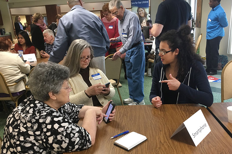 Students help senior citizens with questions about technology