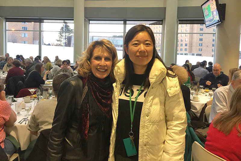 College President Deborah F. Stanley greets Zhiling Yang