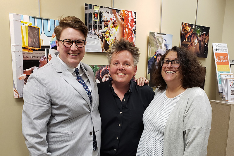 Art faculty member Amy Bartell (center), coordinator of community art exhibitions, greets photographer Katie Simmons-Barth (left) and partner Lisa Simmons-Barth at the opening for Simmons-Barth's exhibition, Resistance, Love and Show Tunes