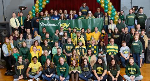 Campus community members in green and gold