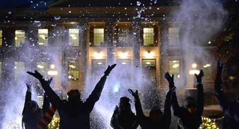 Students having fun in snow in front of Sheldon Hall