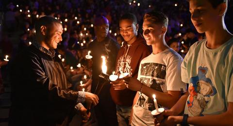 Students hold up candles at Opening Torchlight