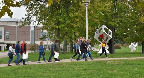 Tour guides leads visitors across campus