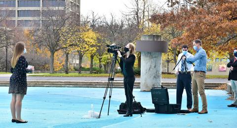 Stephanie Shtoyko (far left), a senior broadcasting major, practices an on-camera news segment as Megan Trubia, a junior broadcasting major, records her during Broadcast News Reporting class taught by Michael Riecke