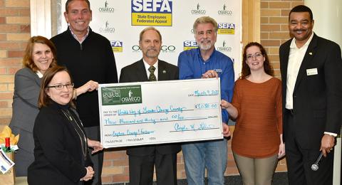 SUNY Oswego's State Employees Federated Appeal (SEFA) fundraising efforts presented $3,030 raised from the Explore Oswego fundraiser for the United Way of Greater Oswego County during a ceremony held March 9 in Marano Campus Center. 