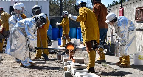 Art technology education students came together to host Oswego's annual Iron Pour on April 22 outside Tyler Hall. Raw iron is heated in an outdoor kiln to 3,000 degrees, then the liquified metal is poured into molds with designs carved by attendees. 