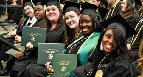 Showing their pride are graduates from the College of Liberal Arts and Sciences, from left, Gabrielle Sennert, Caleb Whyte, Alyson McDonough, Kimberly Reilly, Brittany Ferguson and Lidsai Jammy Jean Baptiste at December 2022 Commencement