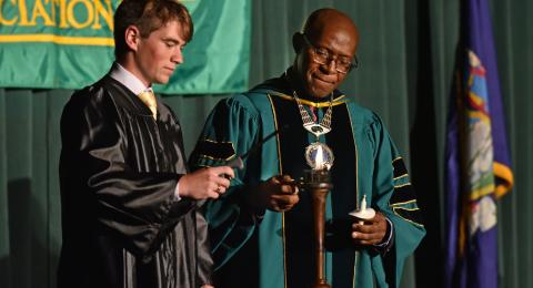 President Peter Nwosu and Student Association President Austin Davis, serving as Torchbearer, light the torch during the Welcoming Torchlight Ceremony