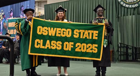 December Commencement celebrated graduates and their many supporters on Dec. 13 in the Deborah F. Stanley Arena and Convocation Hall, Marano Campus Center. President Peter O. Nwosu accepts the Class of 2025 Alumni Banner from student banner presenters