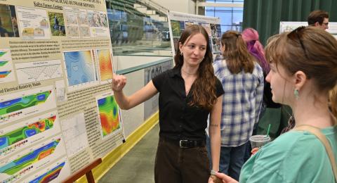 SUNY Oswego’s Quest, held April 22 this year, is an annual symposium dedicated to sharing the scholarly and creative pursuits of students, faculty and staff of SUNY at Oswego. Kailyn Farner, pictured, talks with fellow students during the poster session
