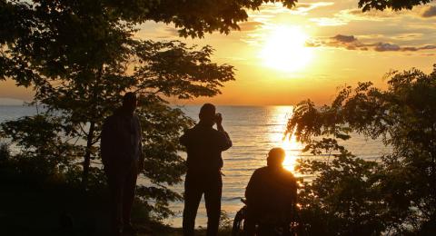 Alumni returning for Reunion admire and take pictures of the Oswego sunset