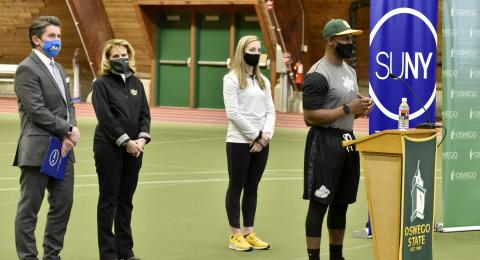 Myles Felton, an outfielder for the Laker baseball team, speaks at a Feb. 23 news conference where SUNY Chancellor Jim Malatras (left) announced that the SUNY Athletic Conference will resume play March 20 for spring sports