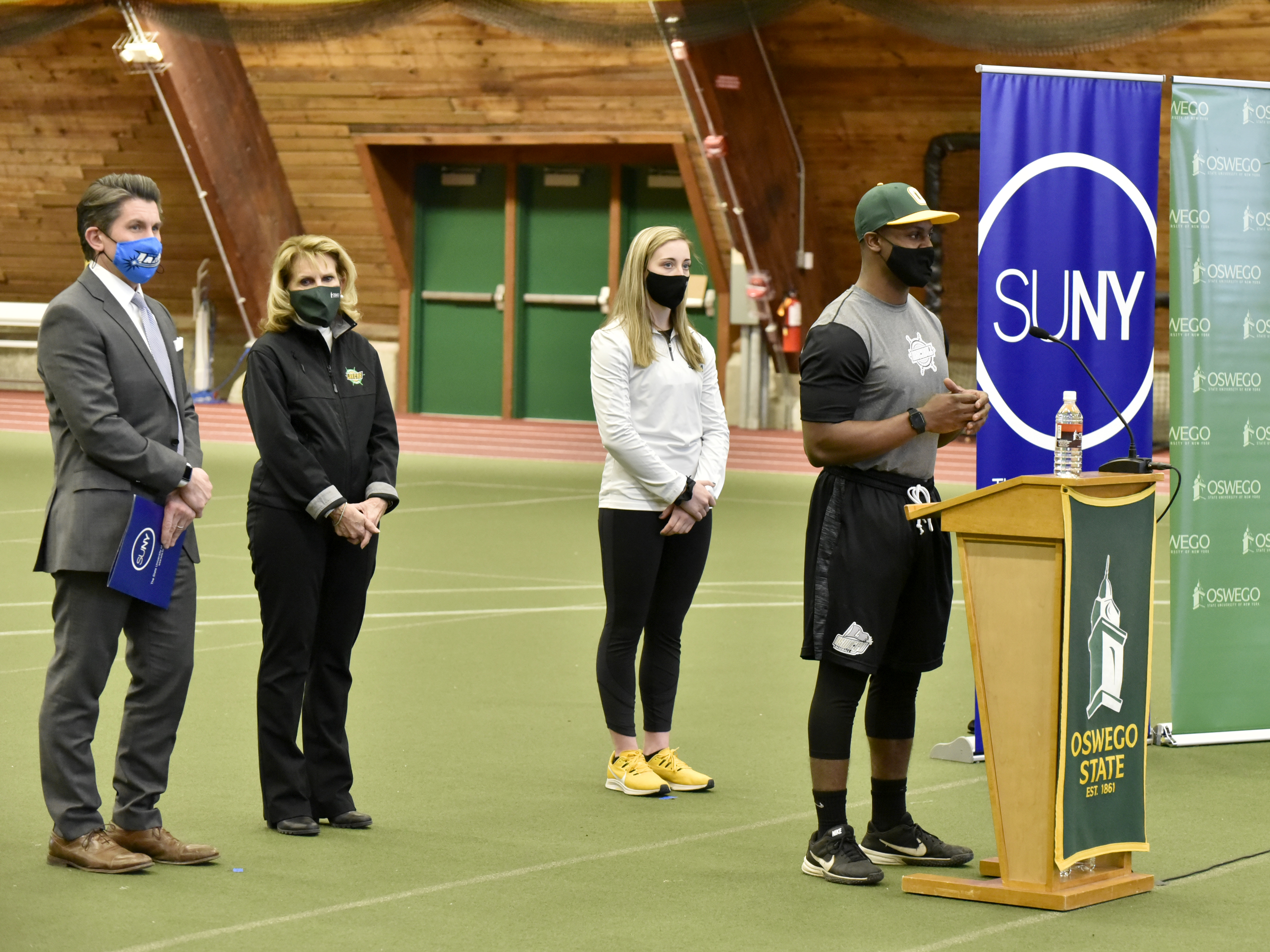 Myles Felton, an outfielder for the Laker baseball team, speaks at a Feb. 23 news conference where SUNY Chancellor Jim Malatras (left) announced that the SUNY Athletic Conference will resume play March 20 for spring sports