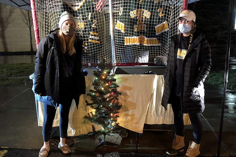 Laker women's hockey players Aislinn McAleer and Kamryn Barnes welcome community donations