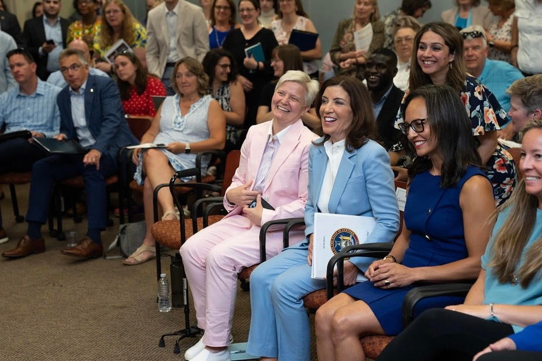 Officer in Charge Mary C. Toale enjoys a New York Department of State at event at SUNY Oswego's Syracuse Campus with Gov. Kathy Hochul and Deputy Secretary of State for Planning, Development and Community Infrastructure Kisha Santiago.