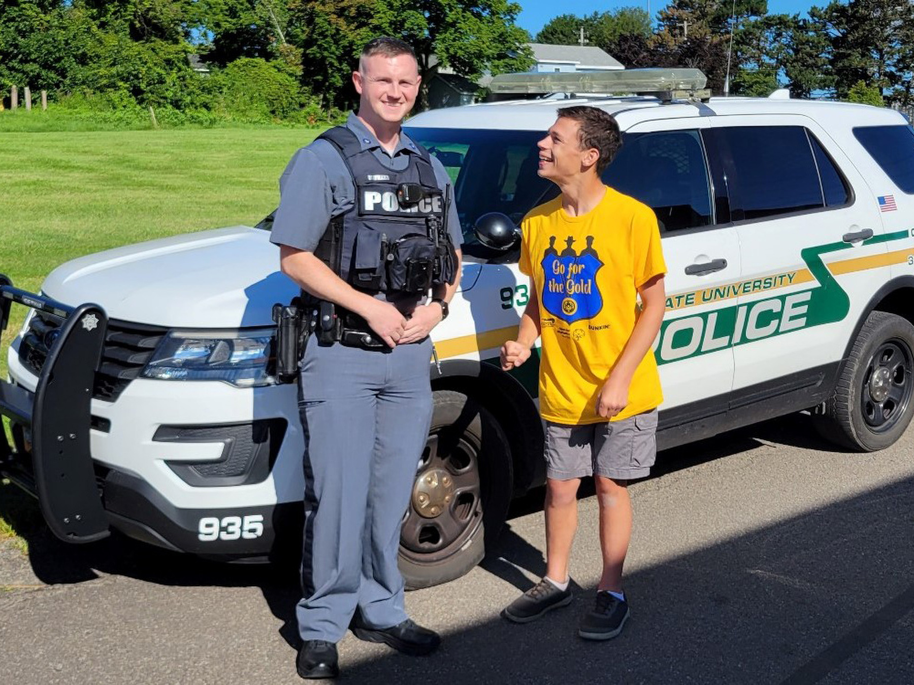 University Police continued its longstanding partnership with Special Olympics by raising $1250 in donations during an Aug. 11 "Go For The Gold" fundraiser at the Dunkin' Donuts just off campus. Shown are Officer Scott Maynard with participant Lou Wildrick from Oswego.