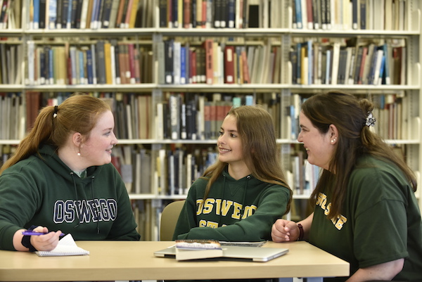 Students around a table in Penfield Library