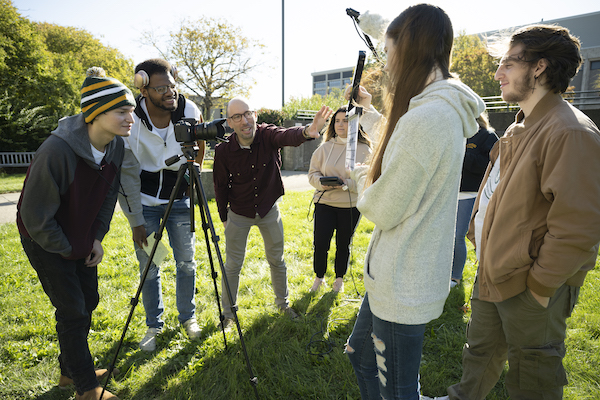 Students with a tripod shooting outside