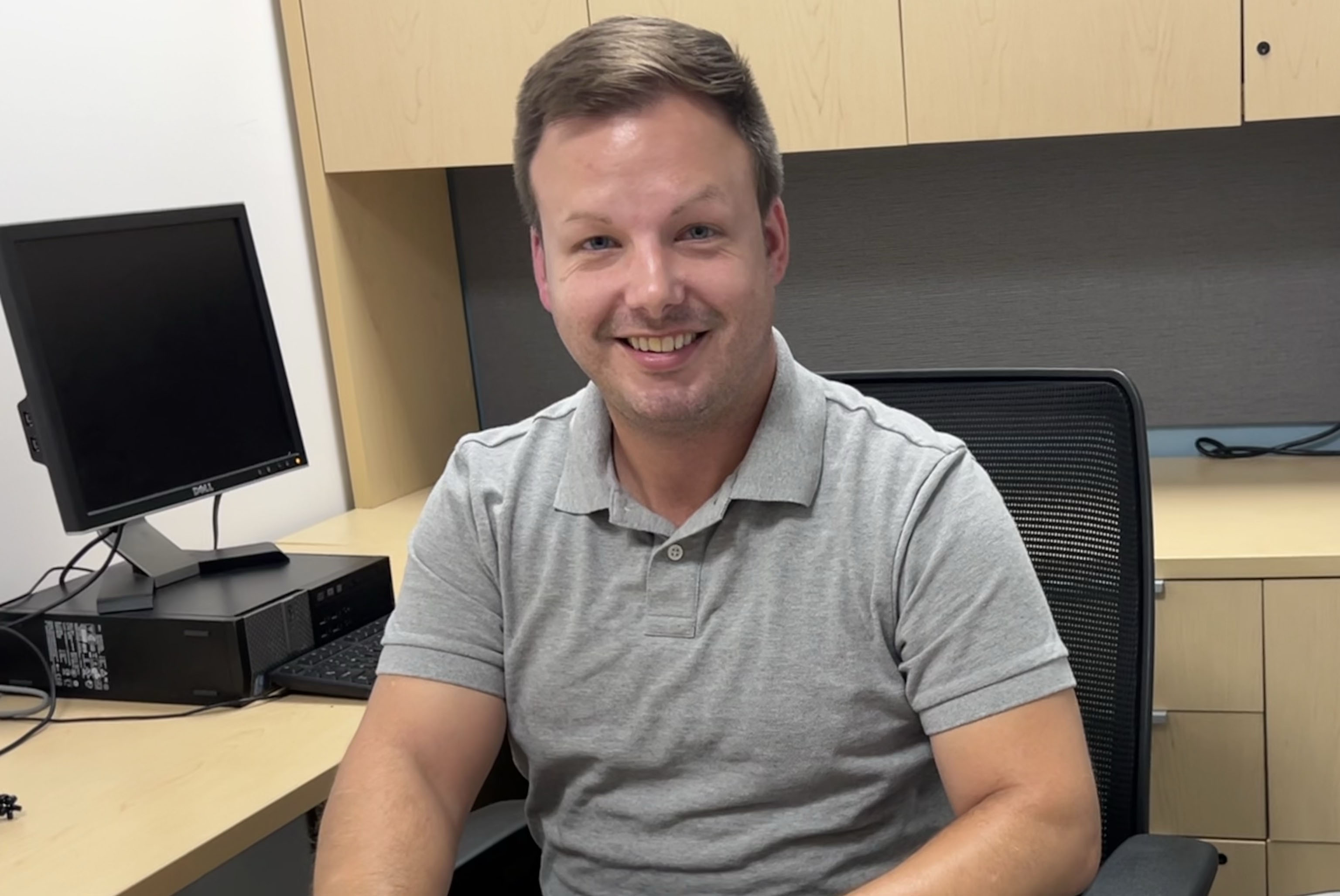 graduate student, Ryan Stiles, working on computer