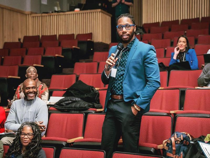 student speaking at an event on a mic