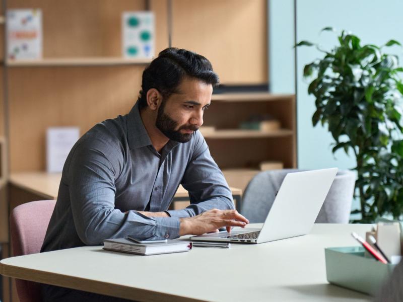 male student studying on a laptop